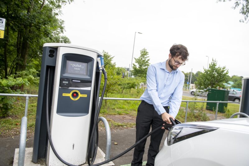 Man using an electric charge point