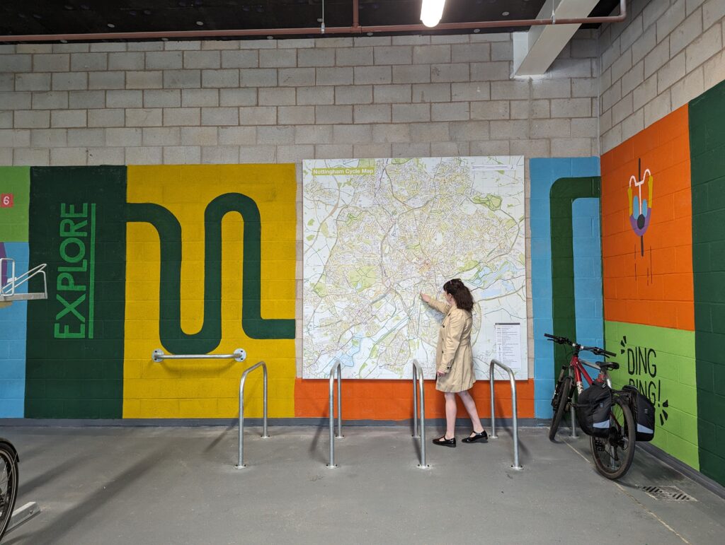 A woman points to a large map of Nottingham's cycle routes.